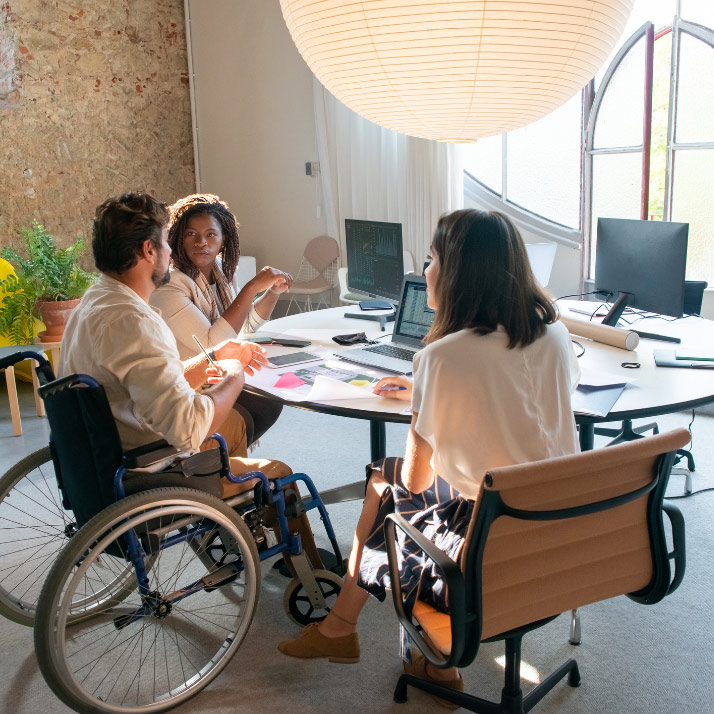 People discussing work activities around table