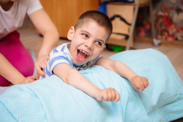Image of little boy with cerebral palsy looking happy