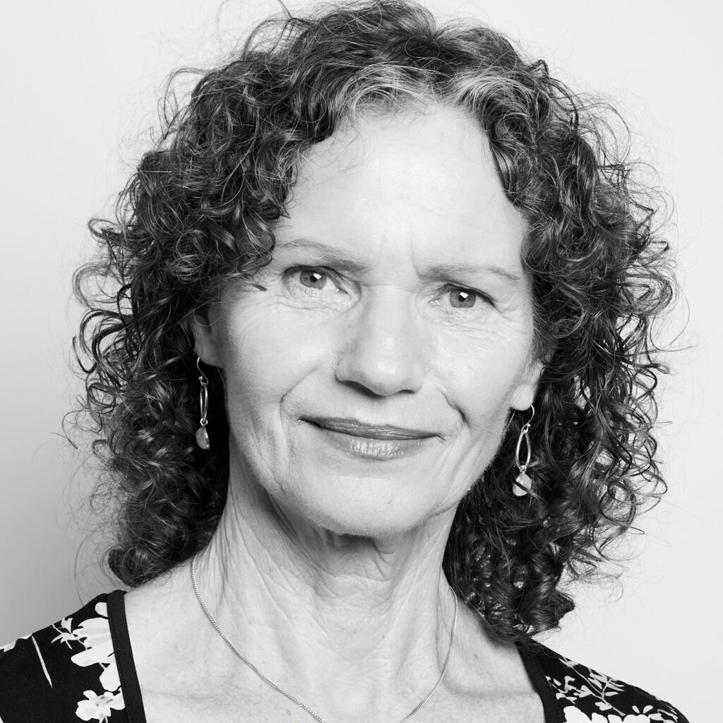 Black and white photo of Susan looking at the camera